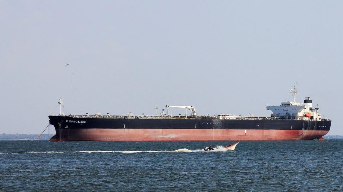 A fisherman's boat sails near the oil tanker Pericles while it is moored on Lake Maracaibo in Maracaibo, Venezuela January 29, 2019. REUTERS/Isaac Urrutia