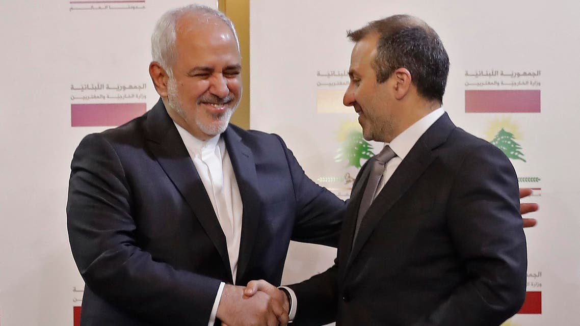 Lebanese Foreign Minister Gibran Bassil shakes hands with his Iranian counterpart Mohammad Javad Zarif