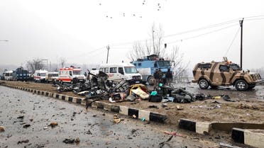 Indian soldiers examine the debris after an explosion in Lethpora in south Kashmir’s Pulwama district on February 14, 2019. (Reuters)