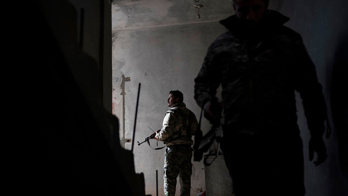 Syrian Democratic Forces fighters walk in a building on Saturday, February 16, 2019, as the fight against ISIS continues in the village of Baghouz, Syria. (AP)