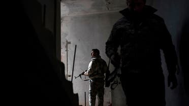 Syrian Democratic Forces fighters walk in a building on Saturday, February 16, 2019, as the fight against ISIS continues in the village of Baghouz, Syria. (AP)