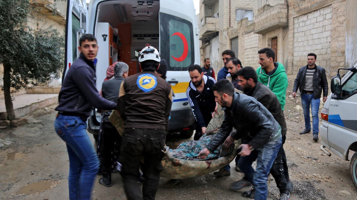 A member (3rd-L) of the Syrian Civil Defence (also known as "The White Helmet") carries a wounded woman following a strike in the town of Khan Shaykhun in the southern countryside of the rebel-held Idlib province, on February 15, 2019.