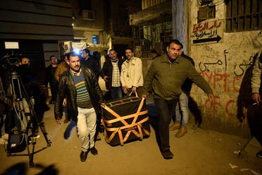 Egyptian police block carry equipment to the site where the body of a suicide bomber lay covered in a sheet behind al-Azhar Mosque in Cairo on February 19, 2019. (AFP)