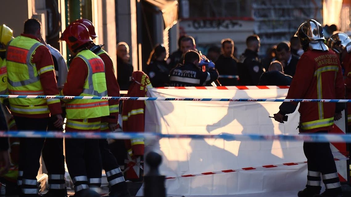 French police and emergency workers intervene in the Canebiere district in Marseille, after a man stabbed two passersby before being himself shot dead by police. (AFP)