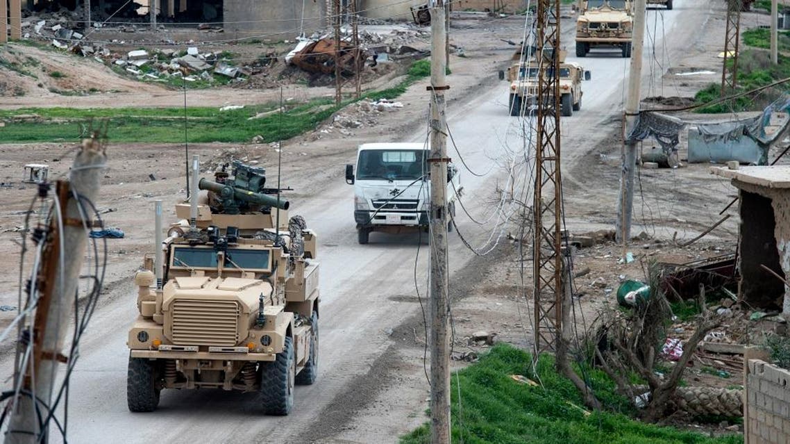 Vehicles belonging to the US-led coalition drive down a street on February 17, 2019, in the frontline Syrian village of Baghuz. (AFP)