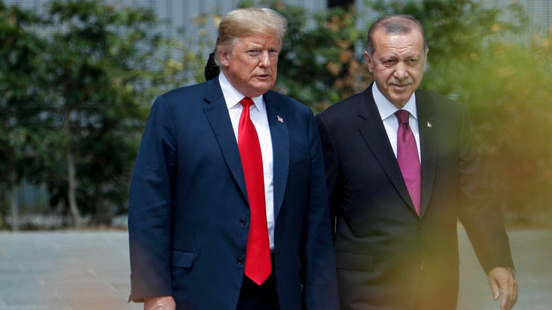 US President Donald Trump (L) speaks to Turkey's President Recep Tayyip Erdogan during the opening ceremony of the NATO (North Atlantic Treaty Organization) summit, at the NATO headquarters in Brussels, on July 11, 2018.