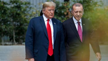 US President Donald Trump (L) speaks to Turkey's President Recep Tayyip Erdogan during the opening ceremony of the NATO (North Atlantic Treaty Organization) summit, at the NATO headquarters in Brussels, on July 11, 2018. 