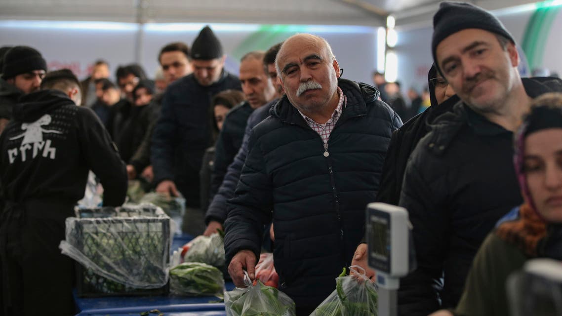 shoppers wait in line to buy groceries at a government-run market in Istanbul (AP)