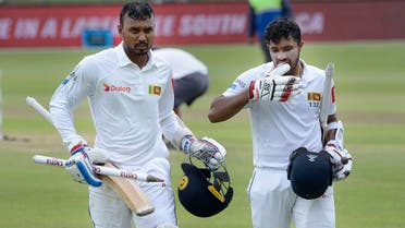 Sri Lanka’s Oshada Fernando (L) and Kusal Mendis walk back to the pavilion after victory in the second Test cricket match between South Africa and Sri Lanka in Port Elizabeth on February 23, 2019. (AFP)