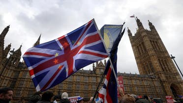 Anti-Brexit campaigners wave flags in front of parliament in London, Wednesday, Dec. 5, 2018. (AP)