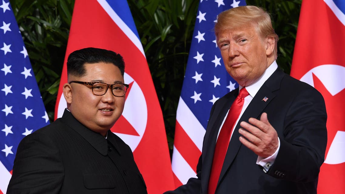 (FILES) This file photo taken on June 12, 2018 shows US President Donald Trump (R) gesturing as he meets with North Korea's leader Kim Jong Un (L) at the start of their historic US-North Korea summit, at the Capella Hotel on Sentosa island in Singapore. US President Donald Trump and North Korean leader Kim Jong Un meet in Hanoi on February 27-28, 2019, faced with putting meat on the bones of the vaguely worded declaration that emerged from their historic first summit in Singapore.