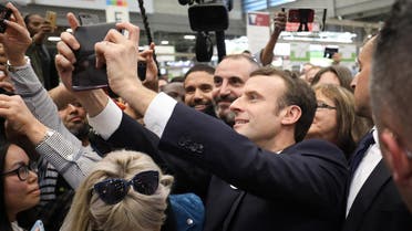 Emmanuel Macron poses for a selfie with visitors during the 56th International Agriculture Fair in Paris, on February 23, 2019. (AFP)