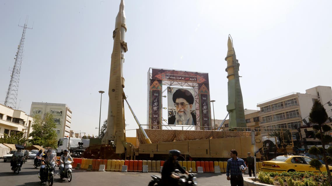 Iranians walk past Sejjil (L) and Qadr-H medium range ballistic missiles displayed next to a portrait of Iranian Supreme Leader Ayatollah Ali Khamenei on the occasion of the annual defence week which marks the anniversary of the 1980s Iran-Iraq war, on September 25, 2017, on Baharestan square in Tehran.