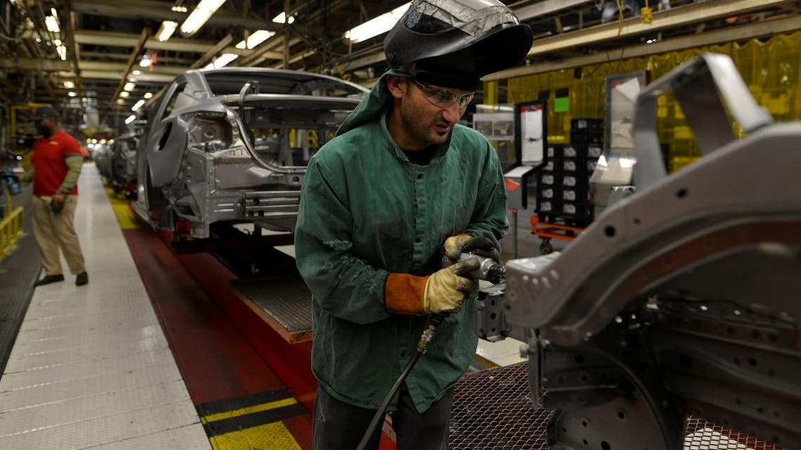 Line workers install the front bumper on the flex line at Nissan’s automobile manufacturing plant in Smyrna, Tennessee, US. (Reuters)