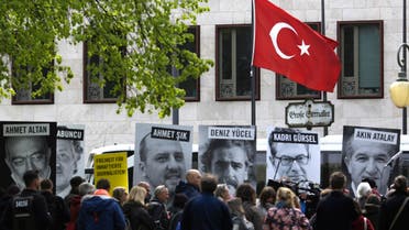 Marking the World Press Freedom Day, activists with Reporters Without Borders hold posters with portraits of journalists detained in Turkey, to protest against the situation for media in the country, in front of the Turkish embassy in Berlin (AP)
