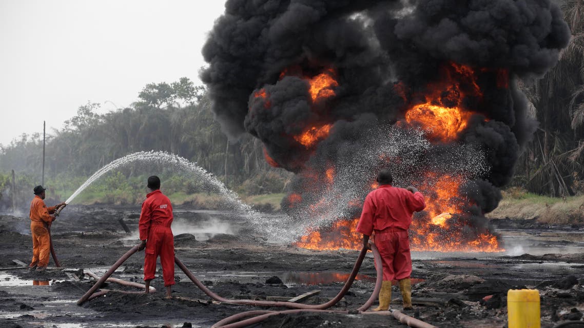 Fire fighters try to contain flames from a burning oil pipeline in Ijeododo outskirt of Lagos, Nigeria (AP)