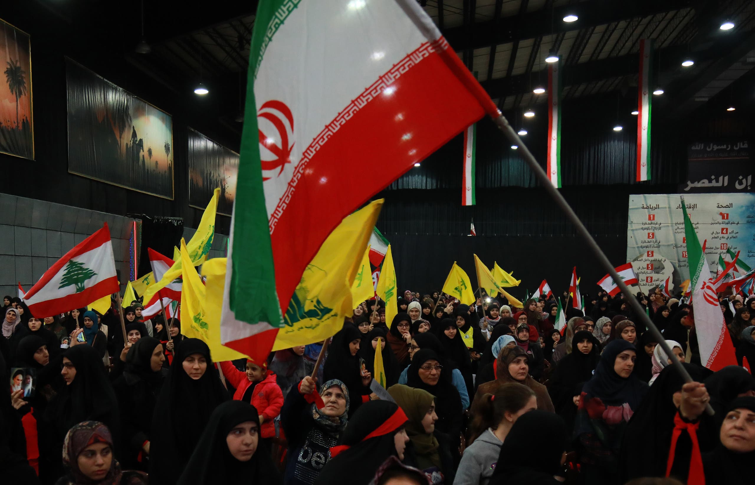 Supporters of Lebanese Hezbollah wave the movement's yellow flag along with Iran's flag during celebrations marking the 40th anniversary of the Iranian revolution in the capital Beirut's southern suburbs on February 6, 2019. 