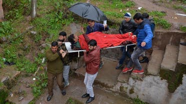 An injured man is carried on a stretcher at a hospital in the Indian Kashmir frontier town of Mendhar on March 2, 2019, after being wounded in his home when it was struck by a mortar shell that his family said was fired by Pakistan troops along the Line of Control (LoC) that divides Kashmir between India and Pakistan. (AFP)