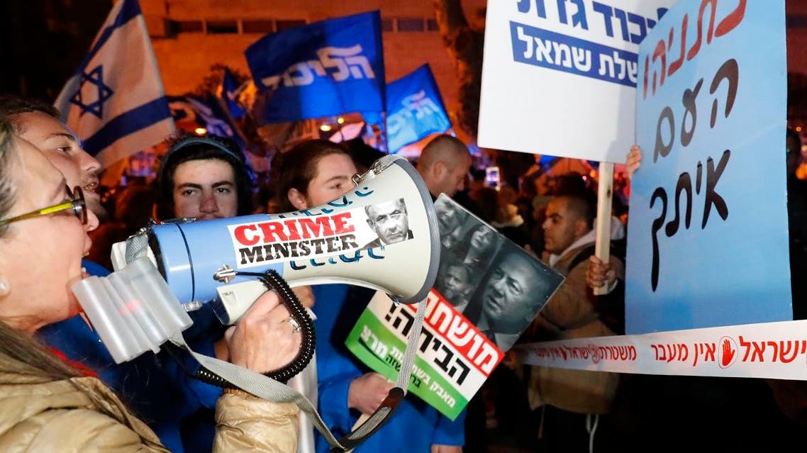 Left-wing demonstrator carry placards and chant slogans during a protest against Israeli Prime minister Benjamin Netanyahu in downtown Tel Aviv on March 2, 2019. (AFP)