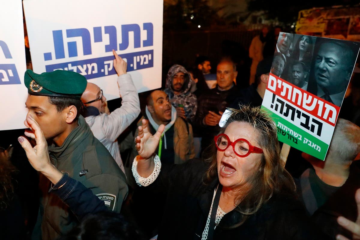 Left-wing demonstrator carry placards and chant slogans during a protest against Israeli Prime minister Benjamin Netanyahu in downtown Tel Aviv on March 2, 2019. (AFP)