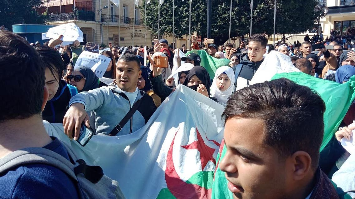 Algerians march with a national flag during a protest rally against ailing President's bid for a fifth term in power, in the northeastern city of Annaba on March 3, 2019.