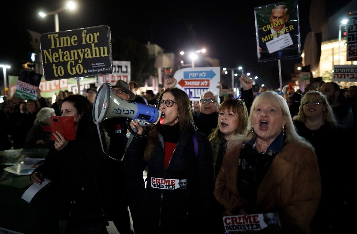Left-wing demonstrator carry placards and chant slogans during a protest against Israeli Prime minister Benjamin Netanyahu in downtown Tel Aviv on March 2, 2019. (AFP)
