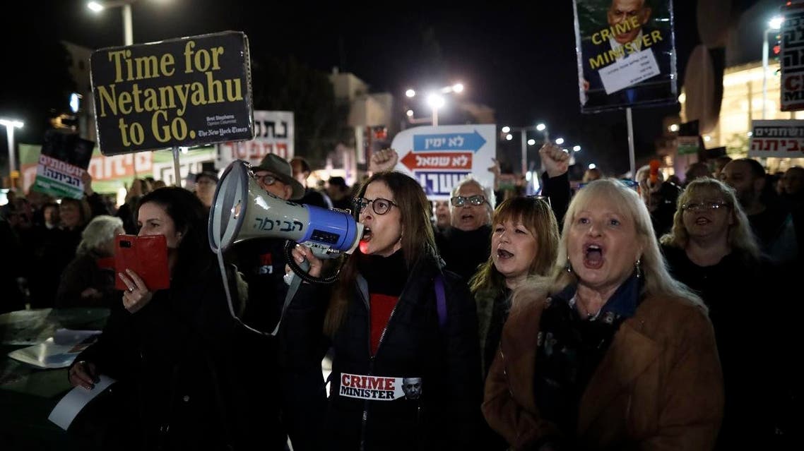 Left-wing demonstrator carry placards and chant slogans during a protest against Israeli Prime minister Benjamin Netanyahu in downtown Tel Aviv on March 2, 2019. (AFP)