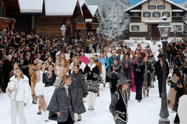Models applaud in tribute to Chanel’s late German fashion designer, Karl Lagerfeld, at the end of the Chanel Women’s fashion show at the Grand Palais, turned into a wintry village in Paris, on March 5, 2019. (AFP)