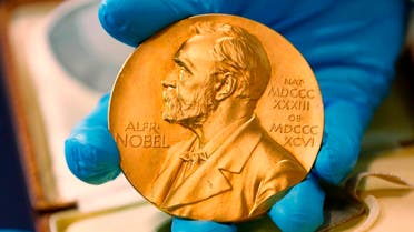 a national library employee shows the gold Nobel Prize medal awarded to the late novelist Gabriel Garcia Marquez, in Bogota, Colombia. (File photo: AFP)