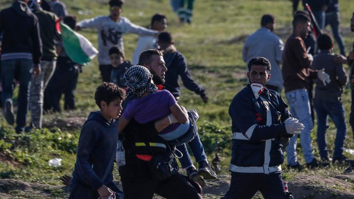 A Palestinian paramedic carries a young wounded protester during clashes with Israeli forces following a demonstration near the fence along the border with Israel, east of Gaza City, on March 8, 2019. (AFP)