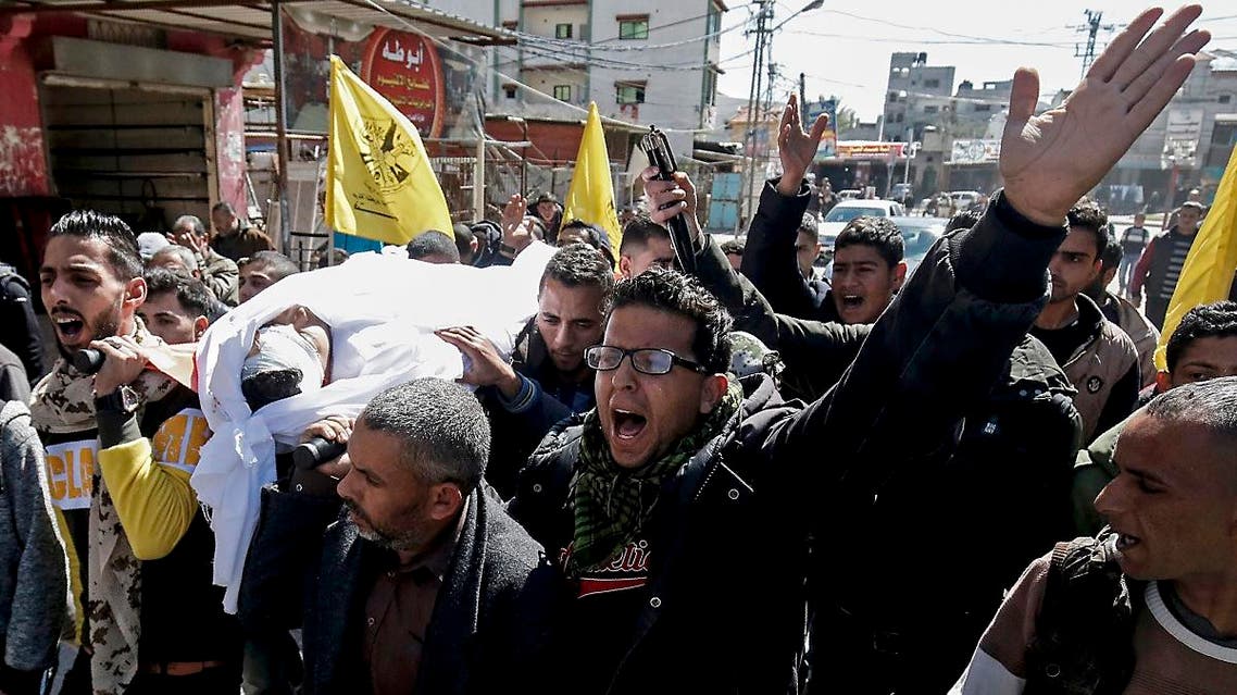 Palestinian mourners carry the body of Tamer Arafat, aged 23, during his funeral in Rafah in the southern Gaza Strip on March 9, 2019. (AFP)