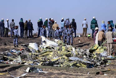 Ethiopian Federal policemen stand at the scene of the Ethiopian Airlines Flight ET 302 plane crash, near the town of Bishoftu. (Reuters)