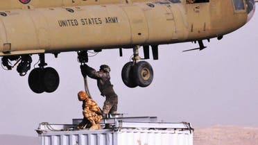 In this photo provided by ISAF Regional Command (South), soldiers from Combined Team Zabul sling-load a container of components for a cell phone tower, on March 25, 2011, at Forward Operating Base Lagman, in the Kandahar province of Afghanistan. The components are being airlifted to the village of Nawbahar.AFP PHOTO/ US Army Sgt. Jerry Wilson/HANDOUT/RESTRICTED TO EDITORIAL USE - MANDATORY CREDIT " AFP PHOTO / - NO MARKETING NO ADVERTISING CAMPAIGNS - DISTRIBUTED AS A SERVICE TO CLIENTS