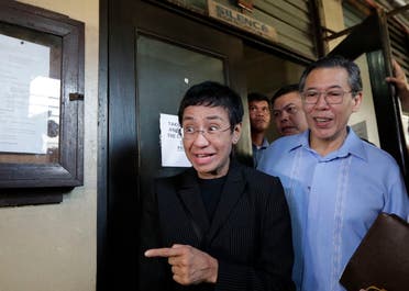 Maria Ressa, head of the Philippine online news site Rappler, gestures as she walks outside the Regional Trial Court branch 46 in Manila, Philippines on Friday, March 1, 2019. (AP)