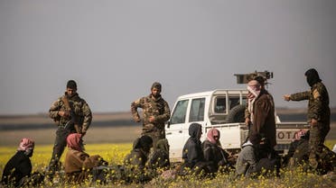 Men suspected of being ISIS extremist fighters arrive at a screening point run by US-backed Syrian Democratic Forces. (AFP)
