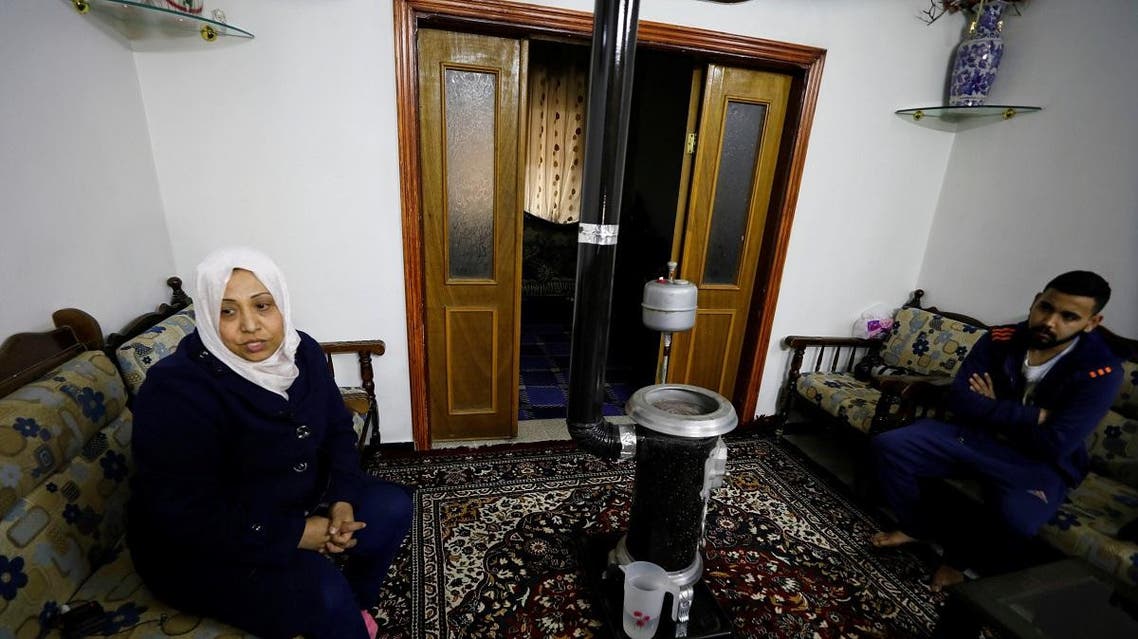 Samiha Fares sits with her son at their house in Ein Terma, a district of eastern Ghouta, Syria. (Reuters)