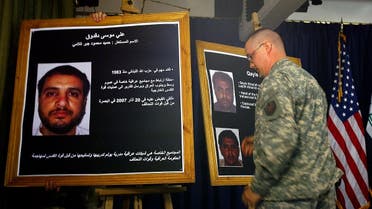 A US solider shows a picture of Ali Mussa Daqduq (L) 02 July 2007 during a press conference at the heavily fortified Green Zone area in Baghdad.US-led forces arrested an Iranian-controlled Lebanese Hezbollah agent in Iraq, where he was training Iraqi extremists. (AFP)