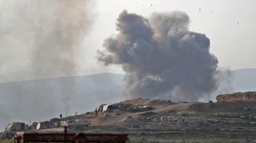 Smoke billows into the sky after reported air strikes on a prison on the western outskirts of Idlib on March 13, 2019. (AFP)