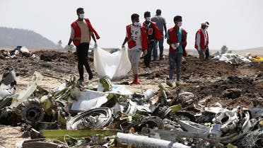 Ethiopian Red Cross workers carry a body bag with the remains of Ethiopian Airlines Flight ET 302 plane crash victims at the scene of a plane crash. (Reuters)