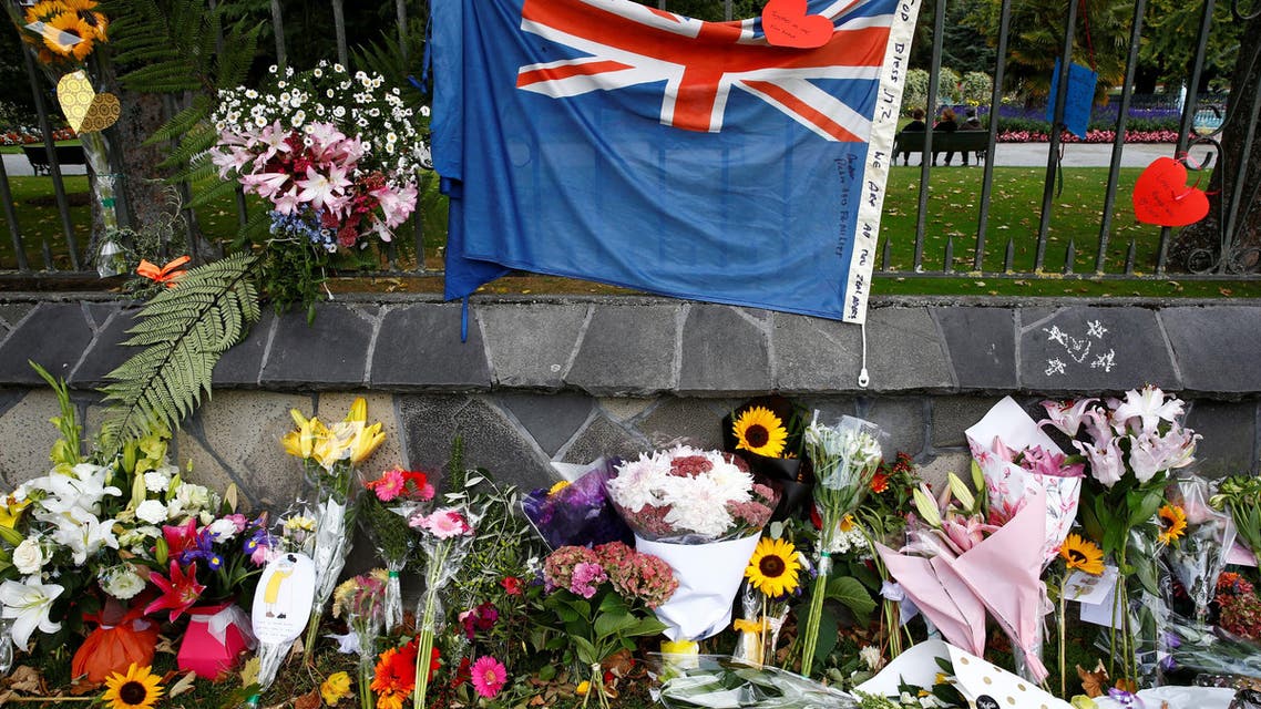 REFILE - CORRECTING BYLINE AND CAPTION Flowers and signs are seen at a memorial as a tribute to victims of the mosque attacks, near a police line outside Masjid Al Noor in Christchurch, New Zealand, March 16, 2019. REUTERS/Jorge Silva