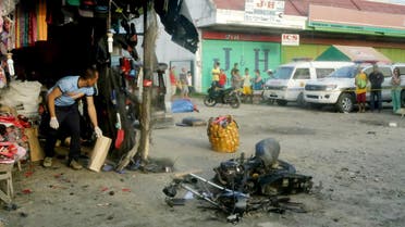 A police investigator gathers evidence at the site of a bomb blast in Isulan town on the southern island of Mindanao. (File photo: AFP)