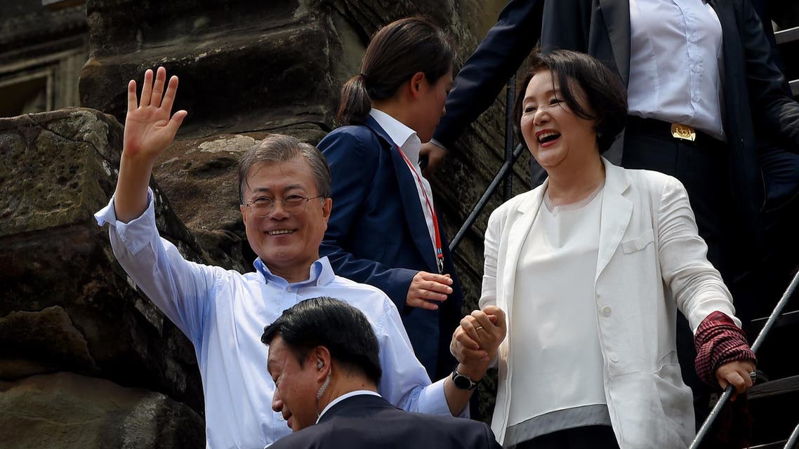 South Korea's President Moon Jae-in and his wife Kim Jung-sook walk down the temple steps during their visit to the Angkor Wat temple on March 16, 2019. (AFP)