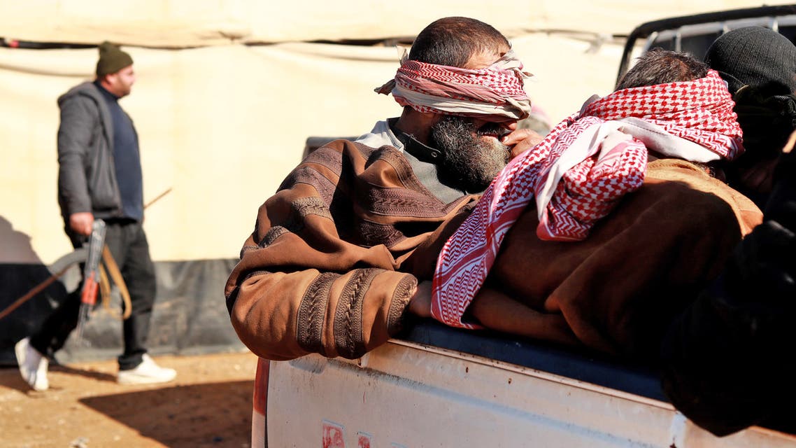 Alleged Islamic State (IS) group fighters who fled from the frontline Syrian village of Baghuz, near the Iraqi border, sit blindfolded in the back of a pickup truck after being taken into custody by SDF forces for screening, near the Omar oil field in the countryside of the eastern Syrian Deir Ezzor province on January 30, 2019.