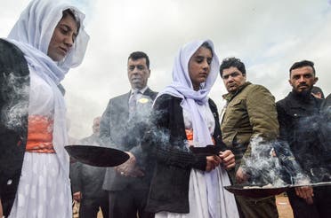 Iraqi authorities exhume a mass grave during an operation aimed at extracting the remains and identifying the victims of an August 2014 massacre of Yazidis by ISIS. (AFP)
