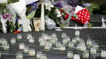 Lit candles are seen in front of floral tributes at a makeshift memorial for victims of the March 15 mosque attacks, in Christchurch on March 17, 2019. (AFP)
