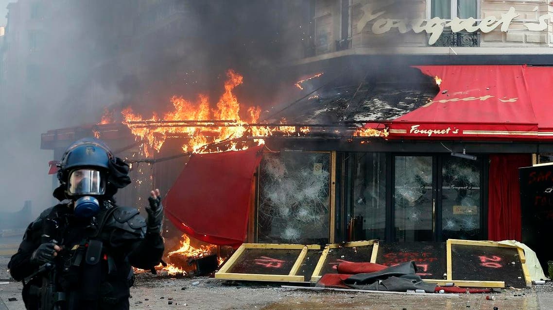 Paris famed restaurant Fouquet's burns on the Champs Elysees avenue during a yellow vests demonstration Saturday, March 16, 2019 in Paris. (AFP)