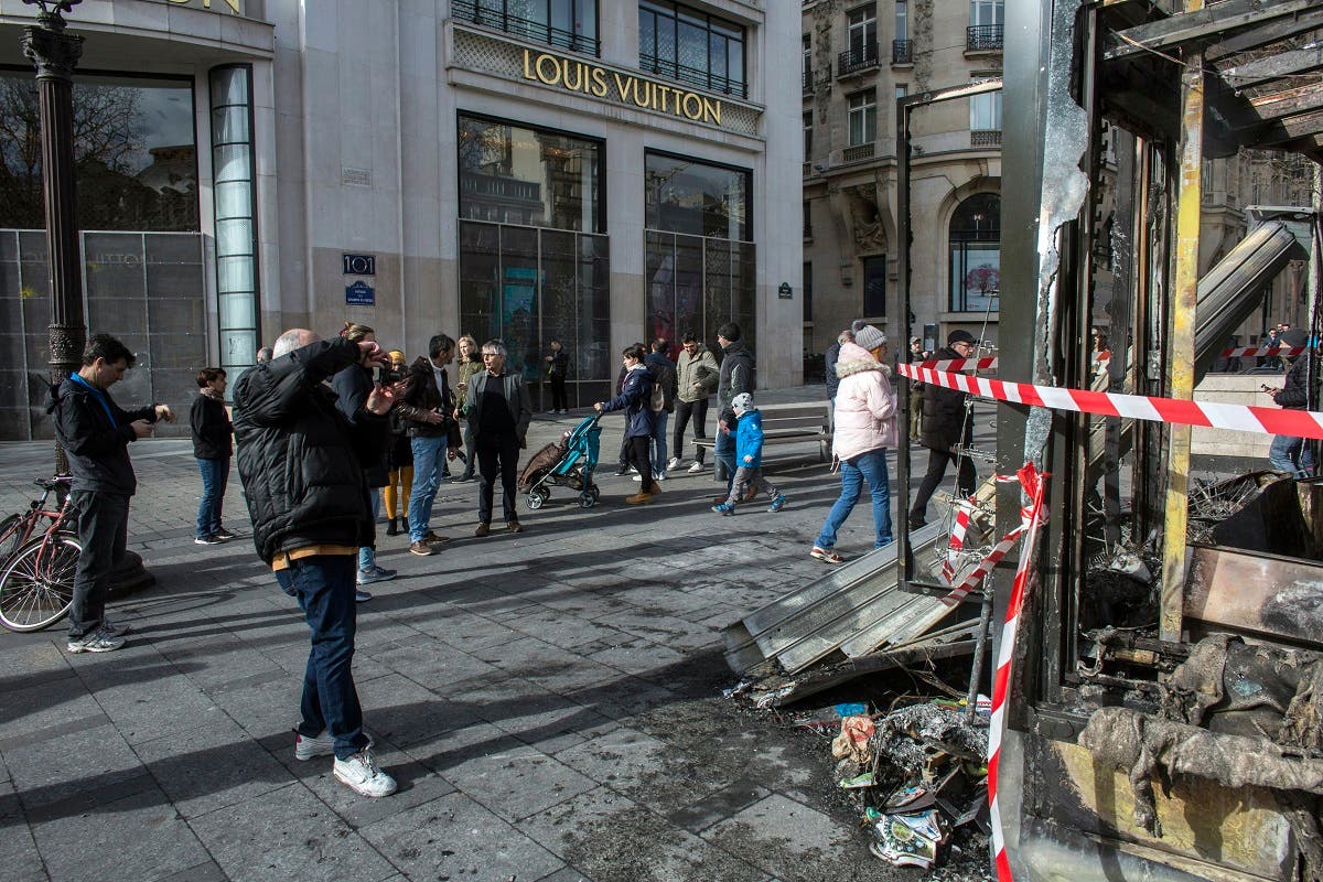 Burned stores on the Champs Elysees avenue during a yellow vests demonstration Saturday, March 16, 2019 in Paris. (AFP)