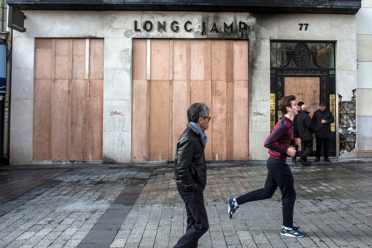 Burned stores on the Champs Elysees avenue during a yellow vests demonstration Saturday, March 16, 2019 in Paris. (AFP)