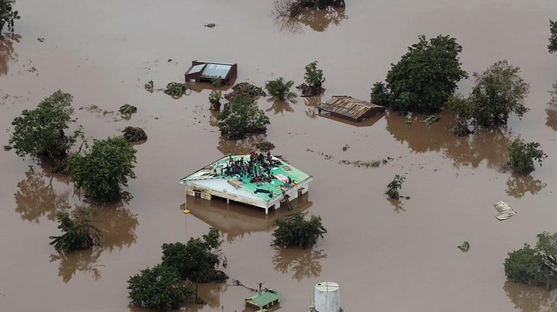 people on a roof surrounded by flooding in an area affected by Cyclone Idai in Beira, Mozambique. (AFP)