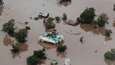  people on a roof surrounded by flooding in an area affected by Cyclone Idai in Beira, Mozambique. (AFP)